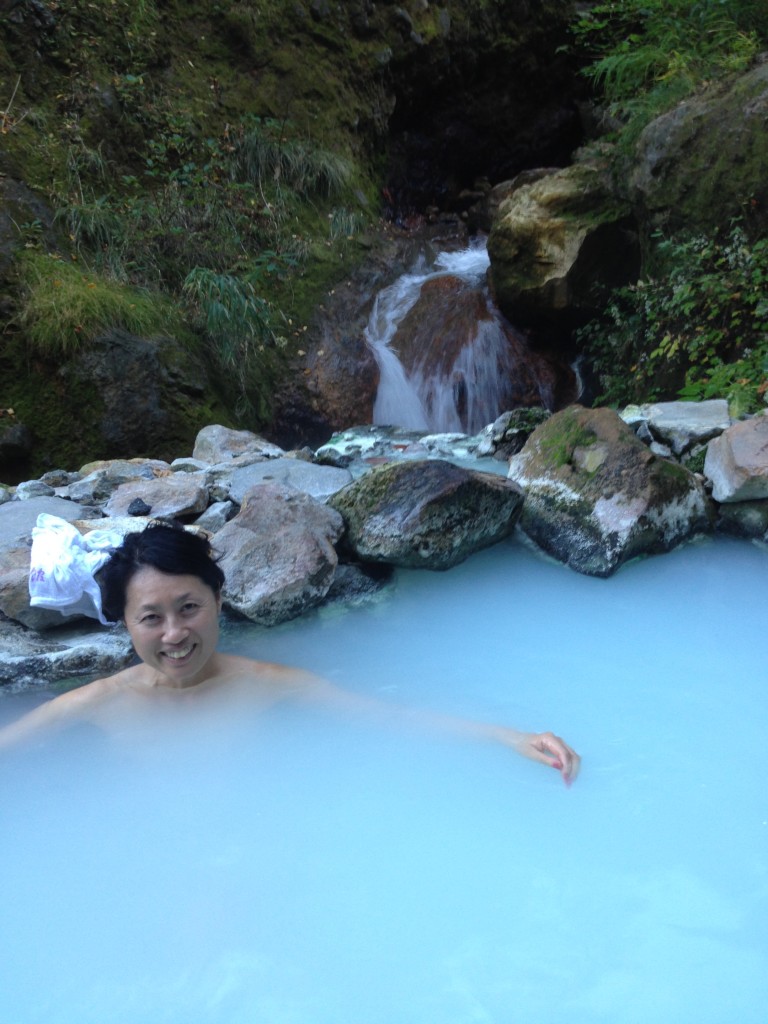 smiling beautiful Japanese woman in outdoor hot spring