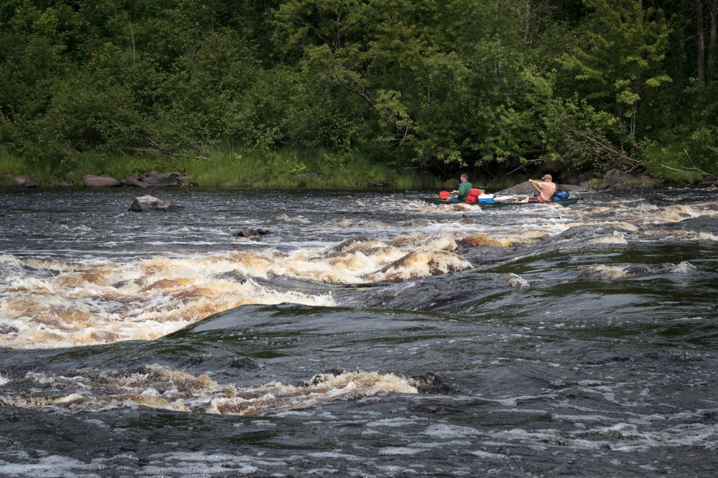 "Here we watch as a flat-bottomed Royalex canoe bounces awkwardly---yet successfully---through Beaver Dam Rapids."