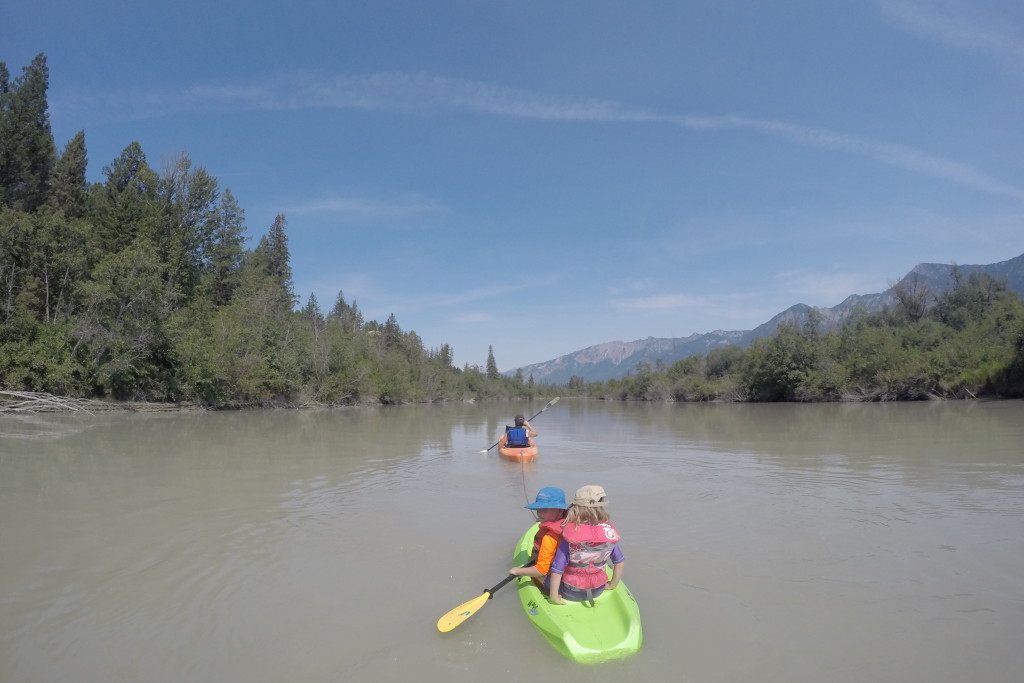 kid-friendly river trip: family paddling down a calm river