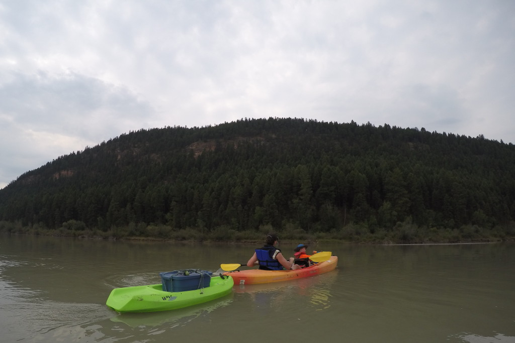 kid-friendly river trip: boat with supplies being paddled on river
