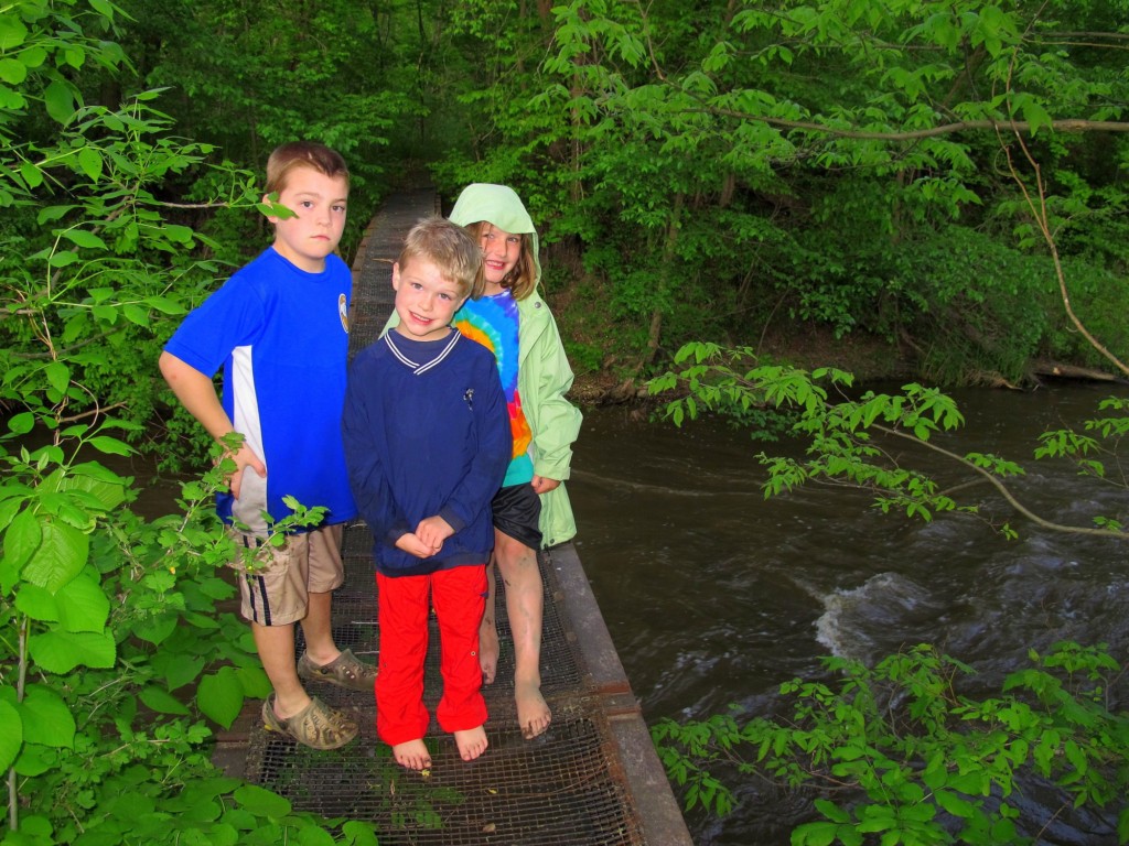 kids standing on footbridge after kayaking on mother's day